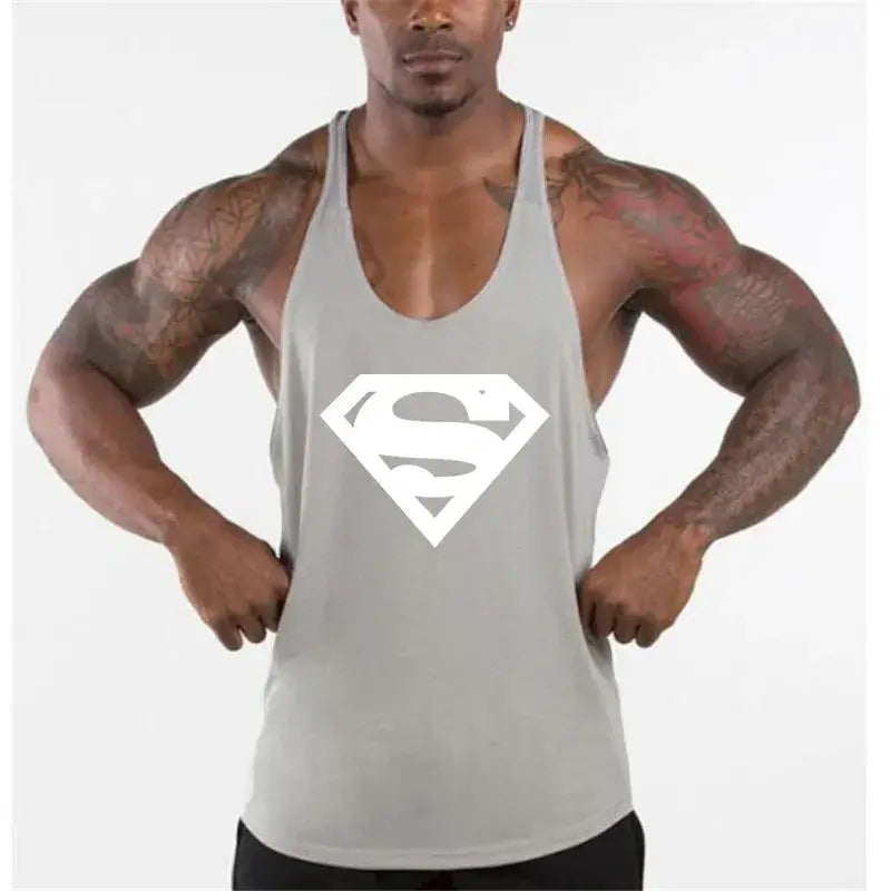 Model wearing men's bodybuilding fitness apparel tank top with Superman logo.