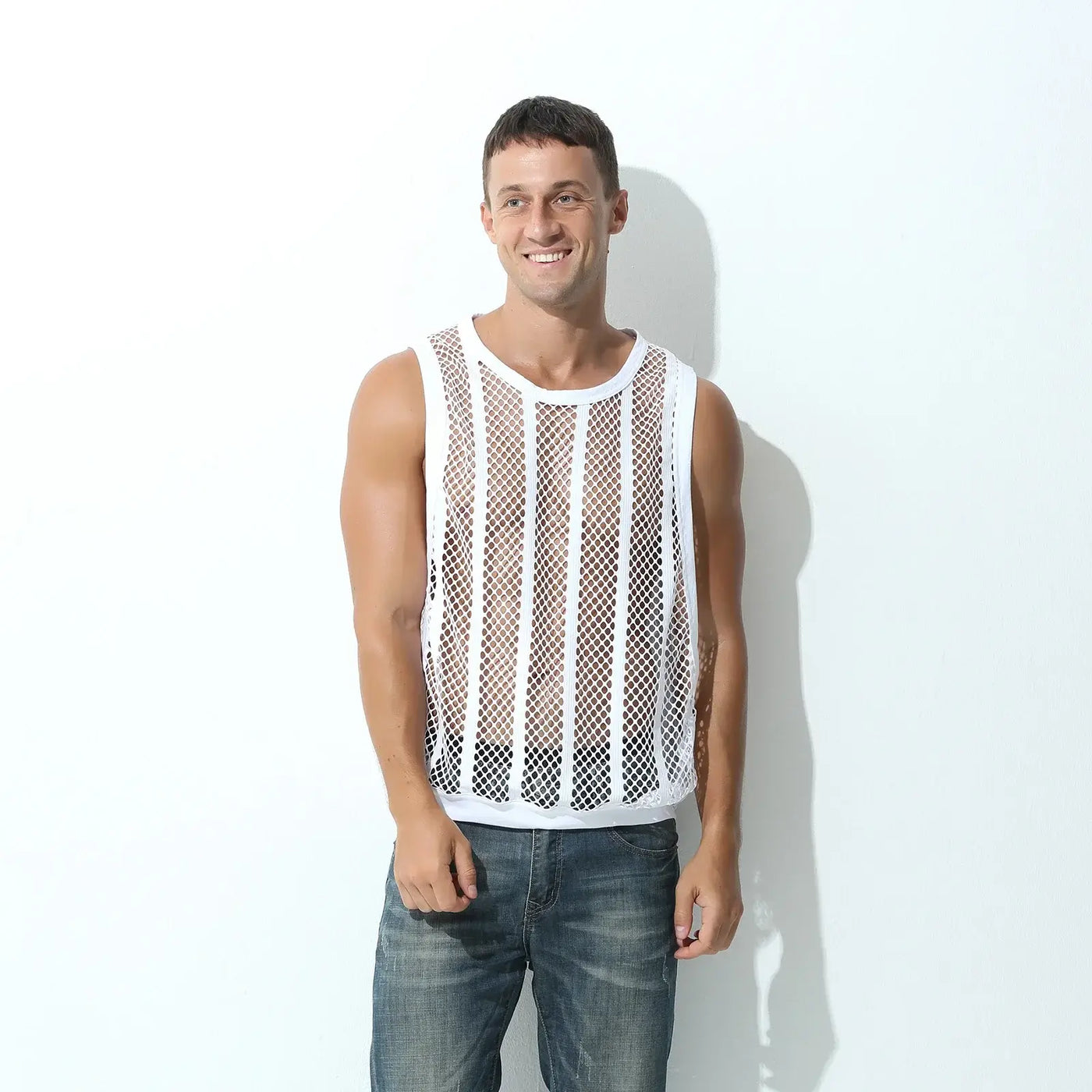 Men Tank Top Sleeveless Undershirt worn by a smiling man standing in casual jeans against a white wall.