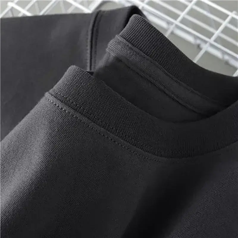 Close-up of the collar and neckline of an engineer t-shirt for men in black, showcasing fabric texture and stitching.